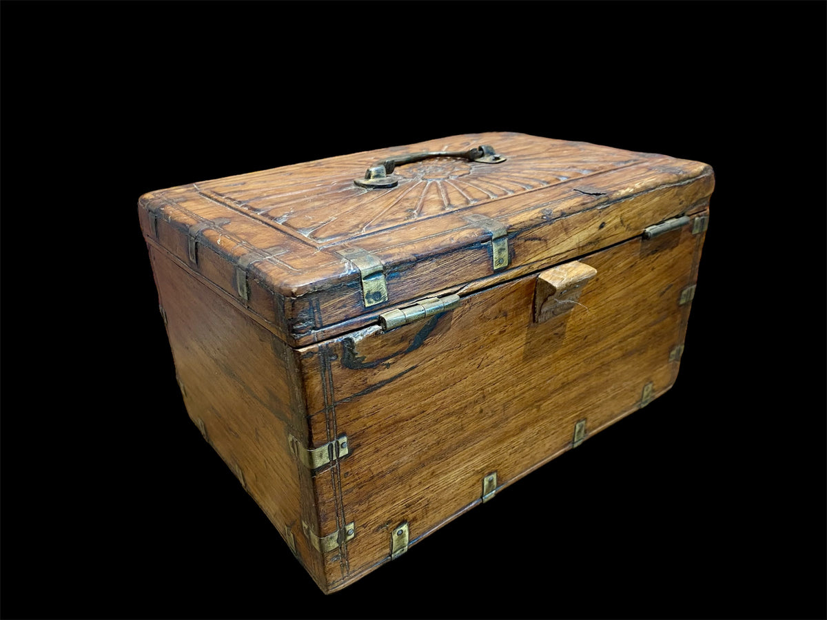 A lovely old southern Indian cash box with carved top and original brass trim, handle and hinges. Fitted with two small shelves inside. Made from teak, this would make a lovely trinket box, key box, jewellery, watch or cufflink box Circa 1880 - 1920. Measurements: length 27.5 cm x depth 19 cm, height 15 cm.