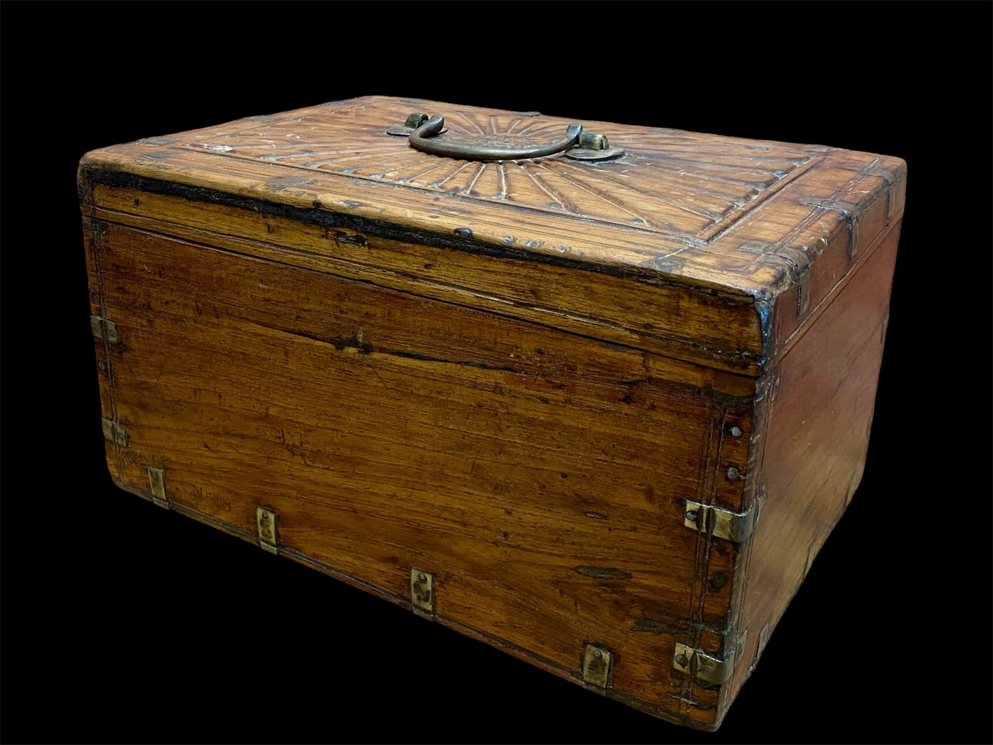 A lovely old southern Indian cash box with carved top and original brass trim, handle and hinges. Fitted with two small shelves inside. Made from teak, this would make a lovely trinket box, key box, jewellery, watch or cufflink box Circa 1880 - 1920. Measurements: length 27.5 cm x depth 19 cm, height 15 cm.