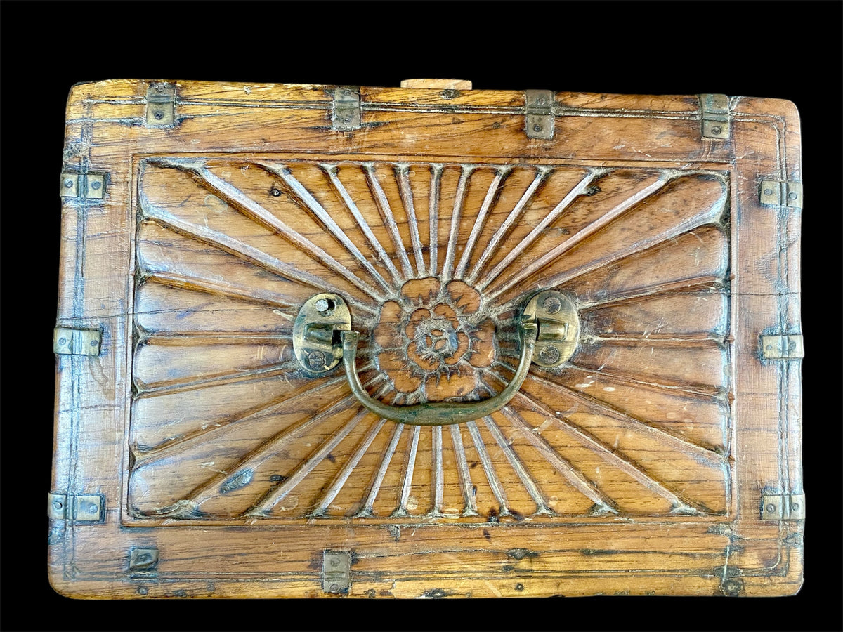 A lovely old southern Indian cash box with carved top and original brass trim, handle and hinges. Fitted with two small shelves inside. Made from teak, this would make a lovely trinket box, key box, jewellery, watch or cufflink box Circa 1880 - 1920. Measurements: length 27.5 cm x depth 19 cm, height 15 cm.