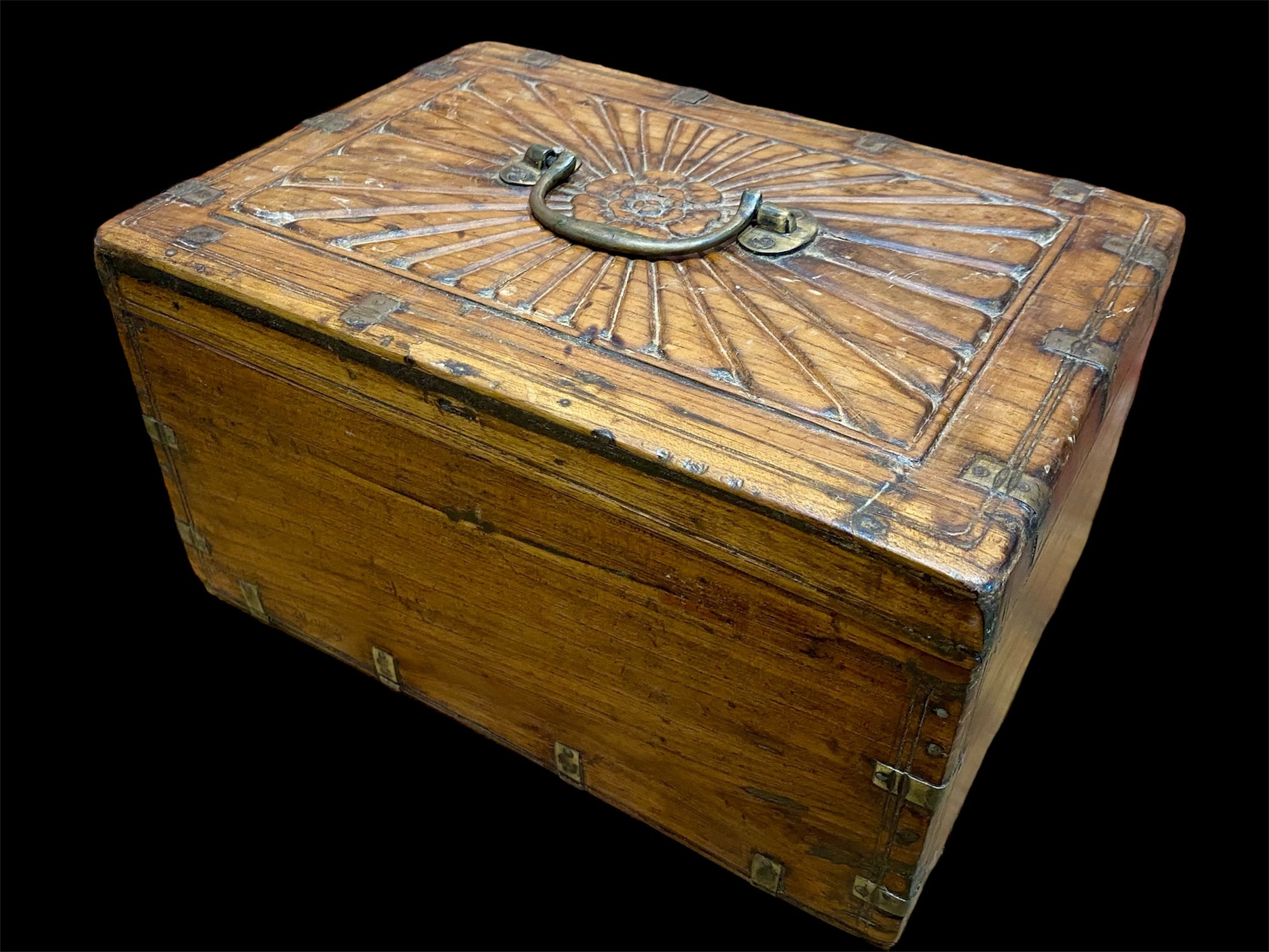 A lovely old southern Indian cash box with carved top and original brass trim, handle and hinges. Fitted with two small shelves inside. Made from teak, this would make a lovely trinket box, key box, jewellery, watch or cufflink box Circa 1880 - 1920. Measurements: length 27.5 cm x depth 19 cm, height 15 cm.