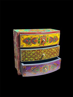 This brightly painted box features three spacious drawers, a curved front and small feet. Brass knobs as handles add a touch of elegance to our storage chest, perfect for holding everything from trinkets to jewellery and essential oils. From Rajasthan, India. Width 23.5, depth 13 cm, height 23 cm