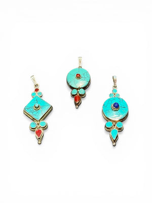 Classic Tibetan pendants, consisting of panels of turquoise and other stones set in sterling silver. These turquoise pendants are handmade in Nepal by Tibetan craftsmen.
