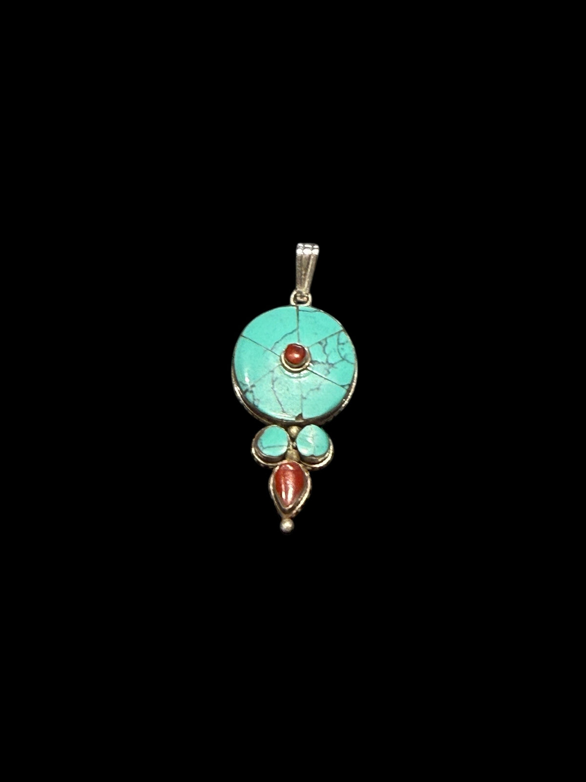 Classic Tibetan pendants, consisting of panels of turquoise and other stones set in sterling silver. These turquoise pendants are handmade in Nepal by Tibetan craftsmen.
