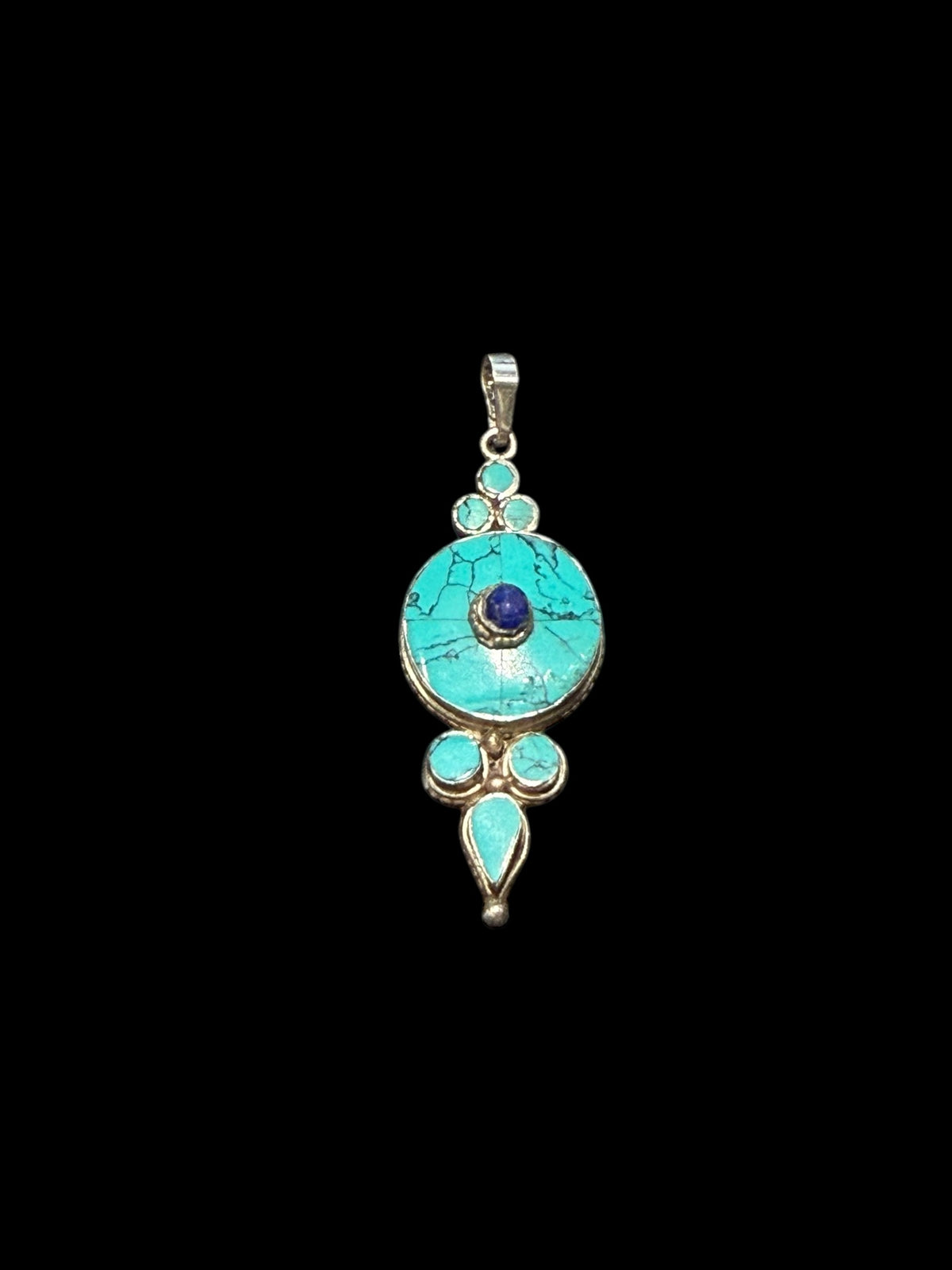Classic Tibetan pendants, consisting of panels of turquoise and other stones set in sterling silver. These turquoise pendants are handmade in Nepal by Tibetan craftsmen.
