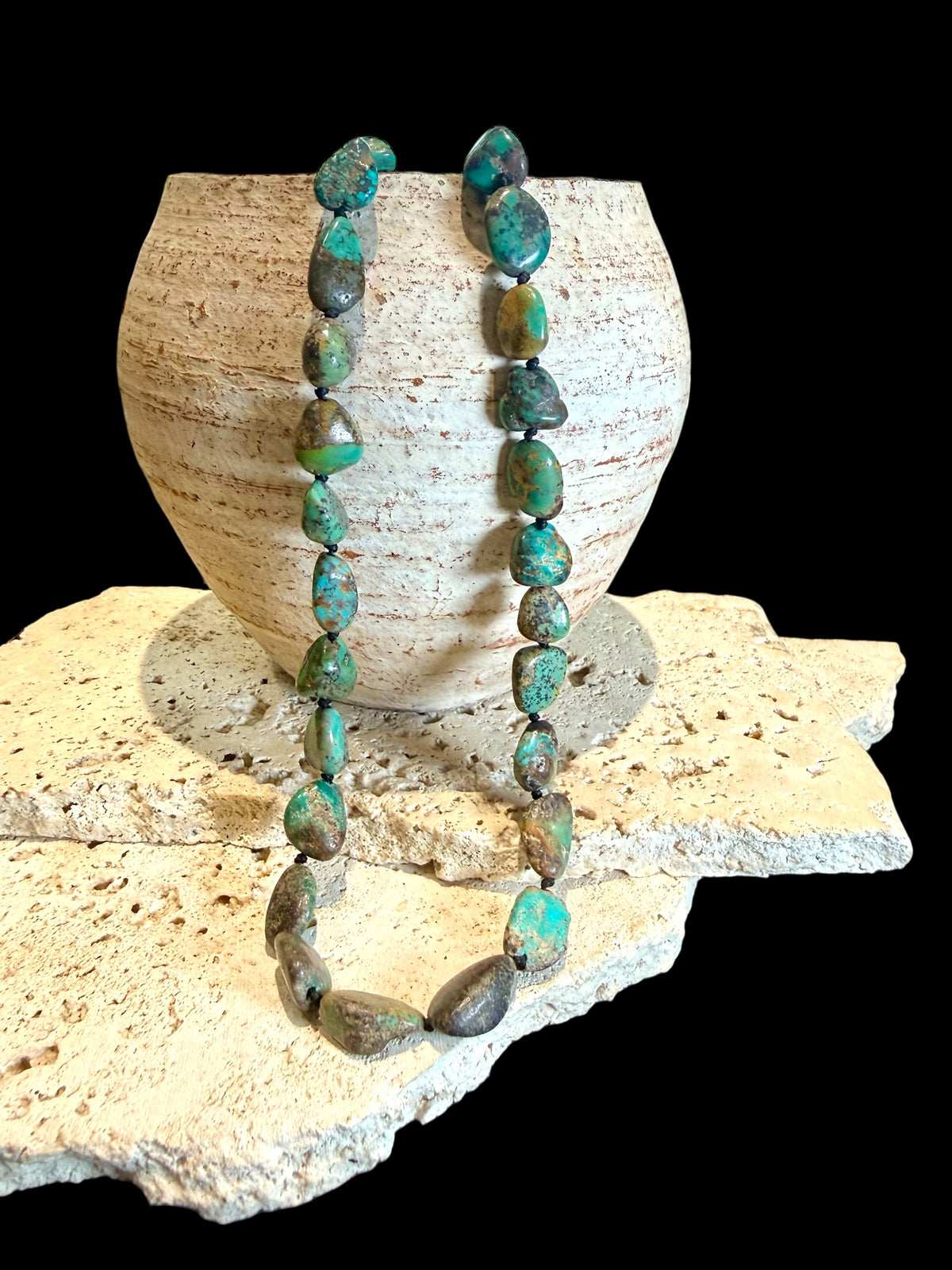 A necklace crafted from Tibetan turquoise, knotted between each bead. Finished with sterling silver beads and clasp, length 53.5 cm