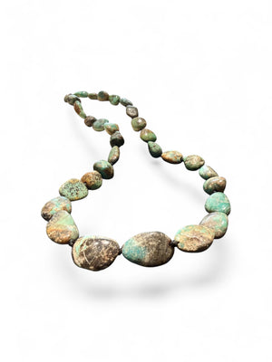 A necklace crafted from Tibetan turquoise, knotted between each bead. Finished with sterling silver beads and clasp, length 53.5 cm