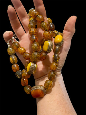 Long statement necklace crafted from vintage Tibetan resin and Bakelite beads, in rich orange tones, circa 1930's. Finished with sterling silver. Length 90.5 cm