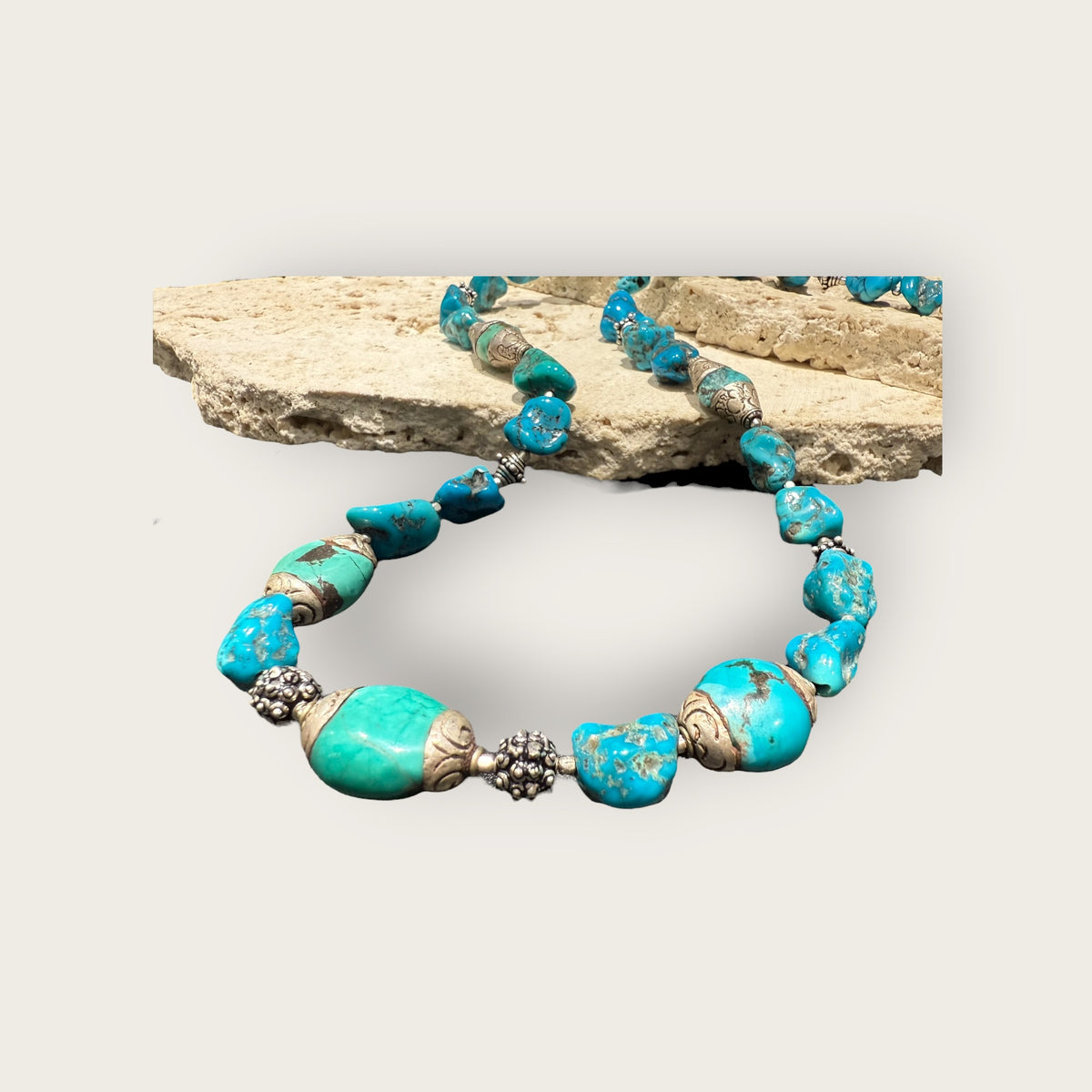 Necklace of Arizona turquoise and vintage Tibetan silver capped turquoise beads. Heavy handmade sterling silver beads from India complete the look. Length 60 cm