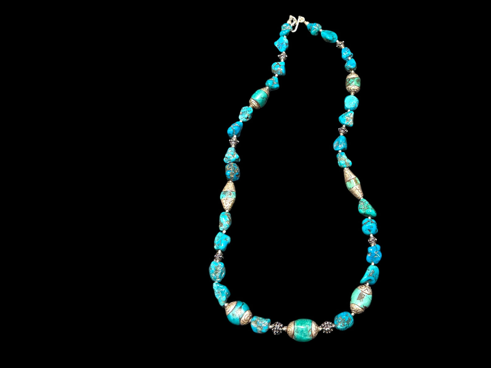 Necklace of Arizona turquoise and vintage Tibetan silver capped turquoise beads. Heavy handmade sterling silver beads from India complete the look. Length 60 cm