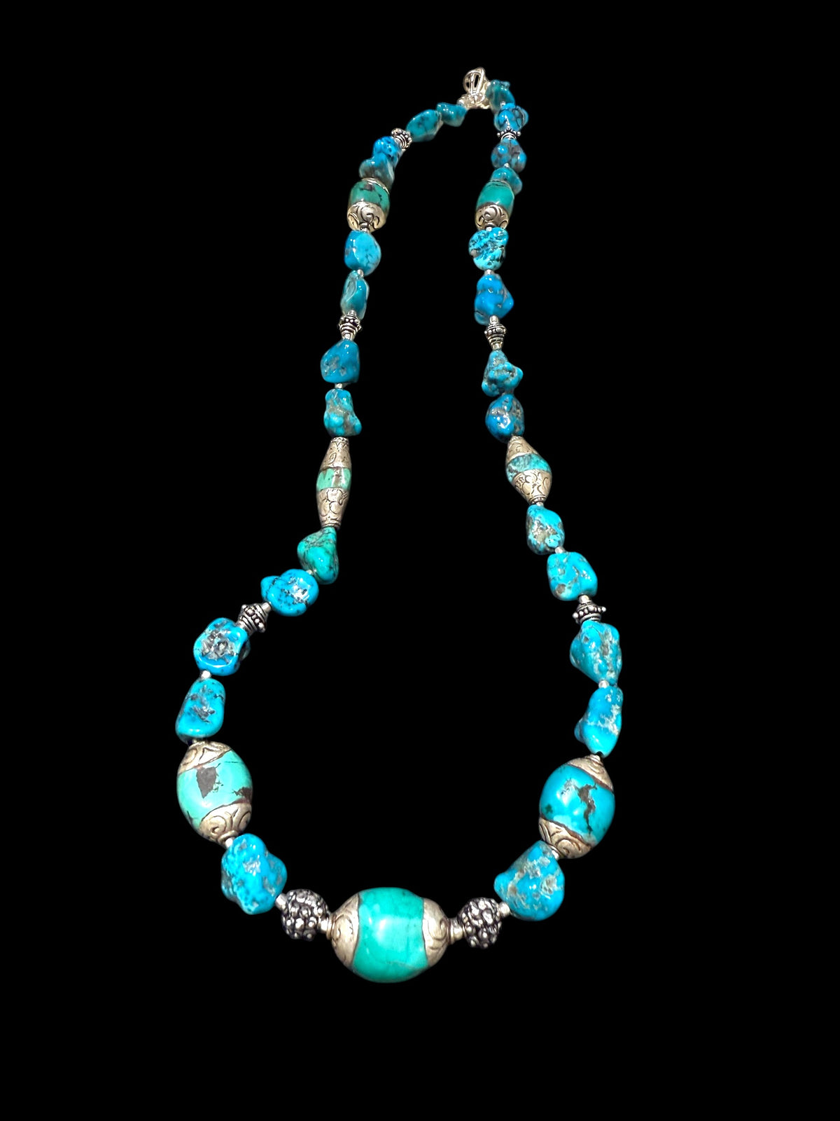 Necklace of Arizona turquoise and vintage Tibetan silver capped turquoise beads. Heavy handmade sterling silver beads from India complete the look. Length 60 cm