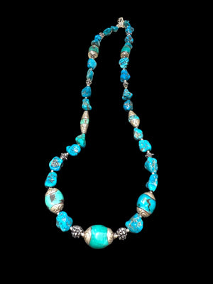 Necklace of Arizona turquoise and vintage Tibetan silver capped turquoise beads. Heavy handmade sterling silver beads from India complete the look. Length 60 cm