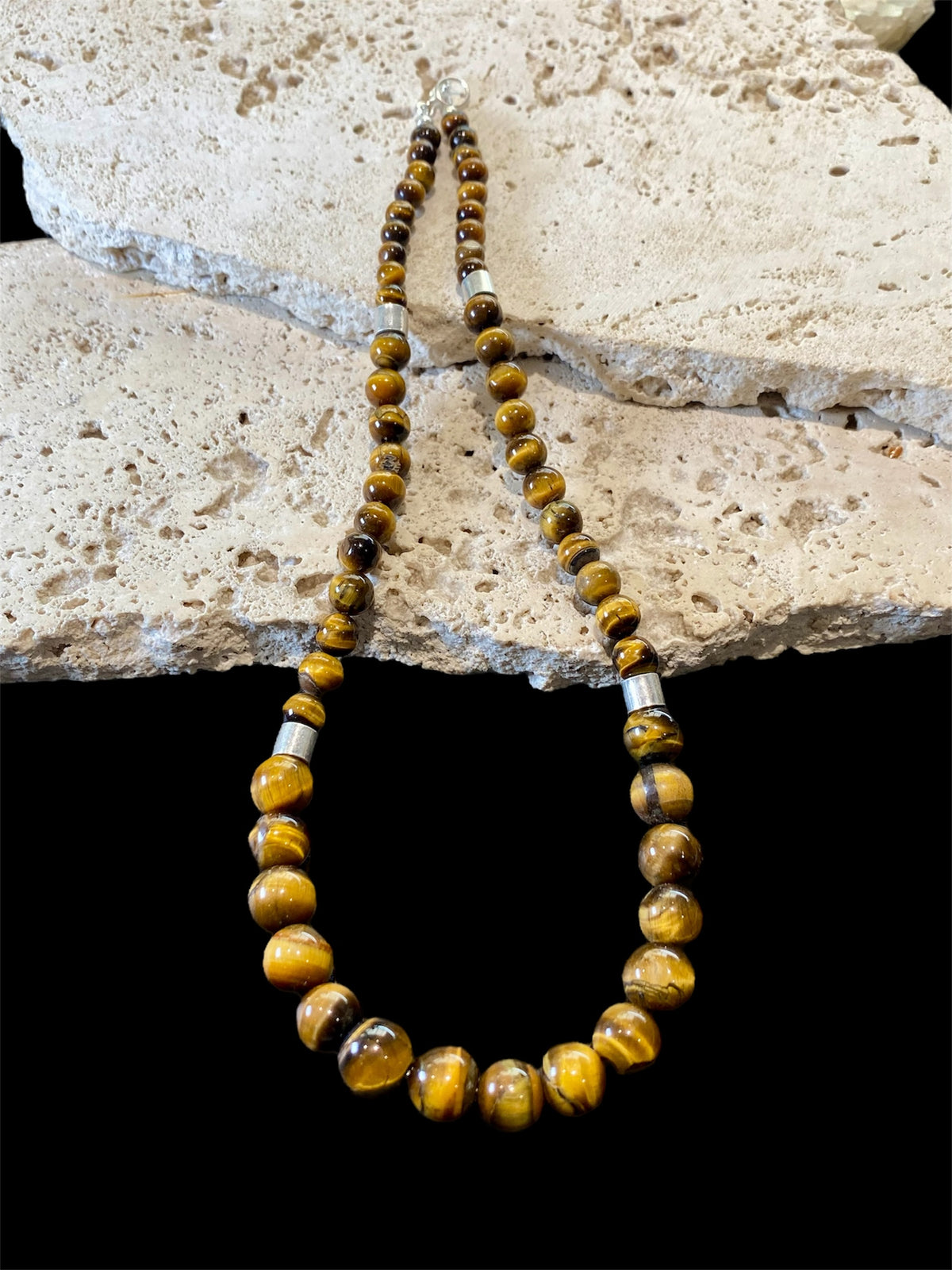 Graduated natural tigers eye necklace feature sterling silver detailing. Length 46 cm