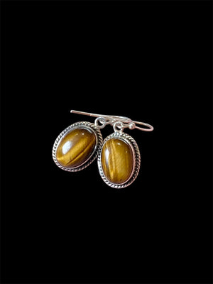 These classic oval earrings feature high quality, large cabochon cut oval tiger's eye stones set in a detailed sterling silver bezel.

Measurements: 3 cm (1.2”) length including hook