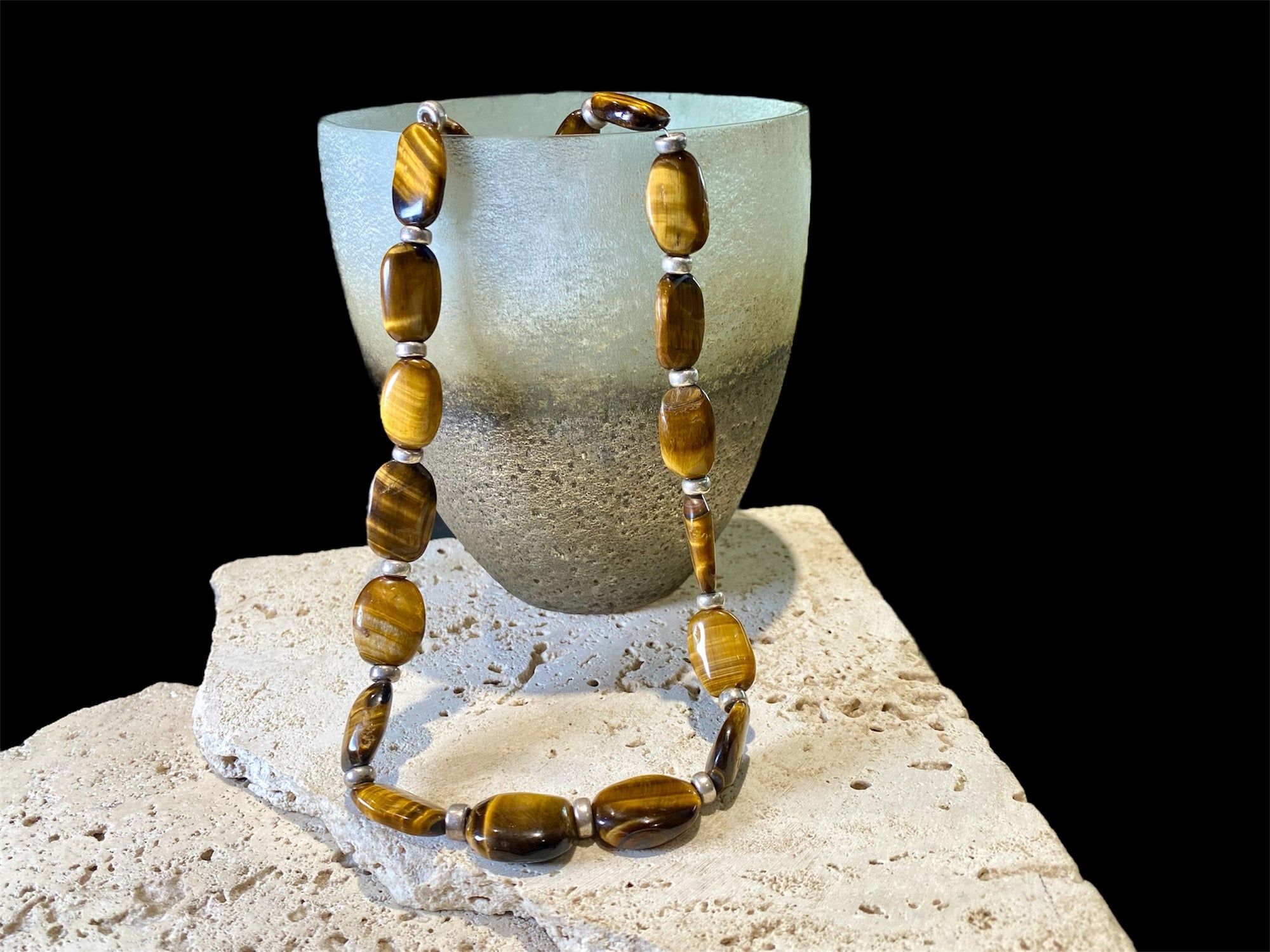 Chunky necklace featuring large pebbles of tigers eye and sterling silver rondel beads, finished with a sterling silver hook clasp. Length 48 cm