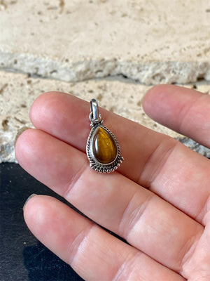 Teardrop tigers eye pendant. Set in sterling silver with a wide bail capable of taking a sizeable silver chain. Open at the back. Height including bail 2.5 cm