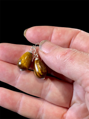 A simple earring consisting of a large teardrop of tigers eye, finished with sterling silver detailing and hooks.

Measurements: length 3 cm