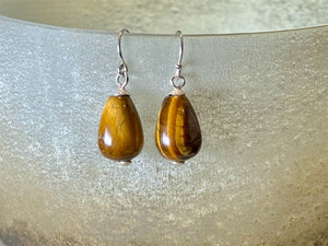 A simple earring consisting of a large teardrop of tigers eye, finished with sterling silver detailing and hooks.

Measurements: length 3 cm