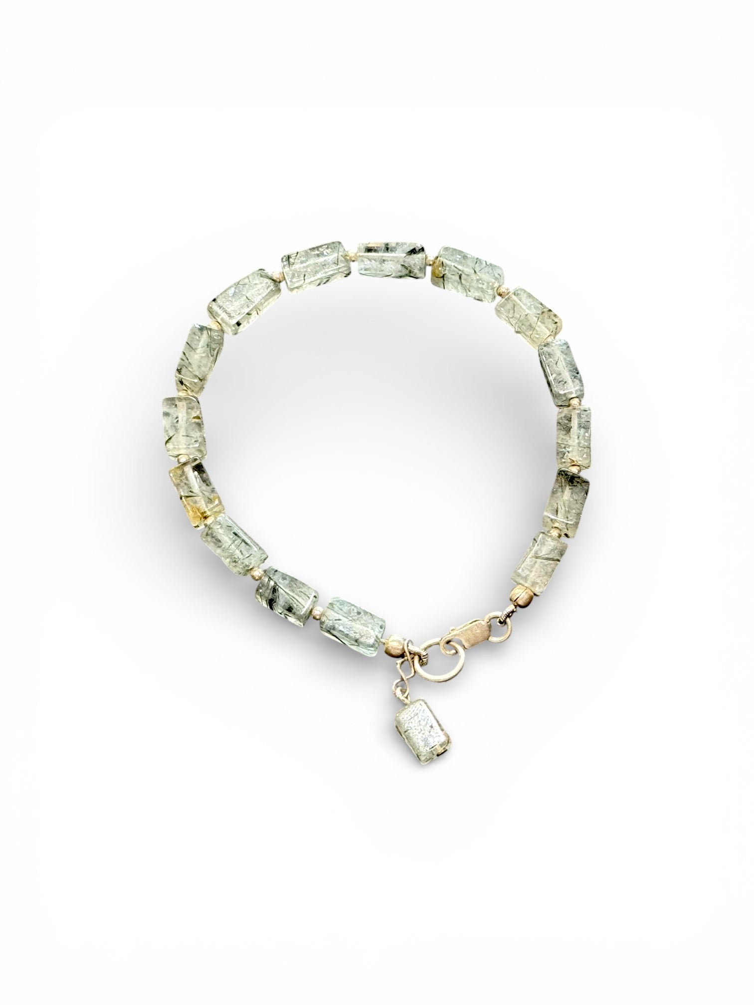 Elegant bracelet of hand cut quartz beads shot through with crystals of tourmaline, finished with sterling silver beads and clasp. Length 19 cm, size 17 cm