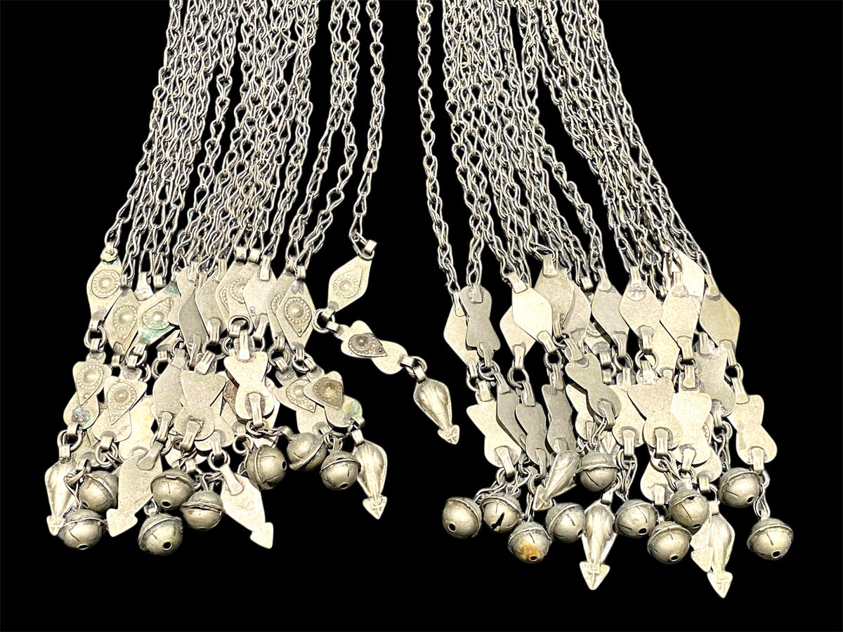 Turkoman headdress jewellery. Low grade or no silver, carnelian and glass stones, leaf and diamond shaped dangles and bells. Ersari. Mid 20th C. Length 43 cm