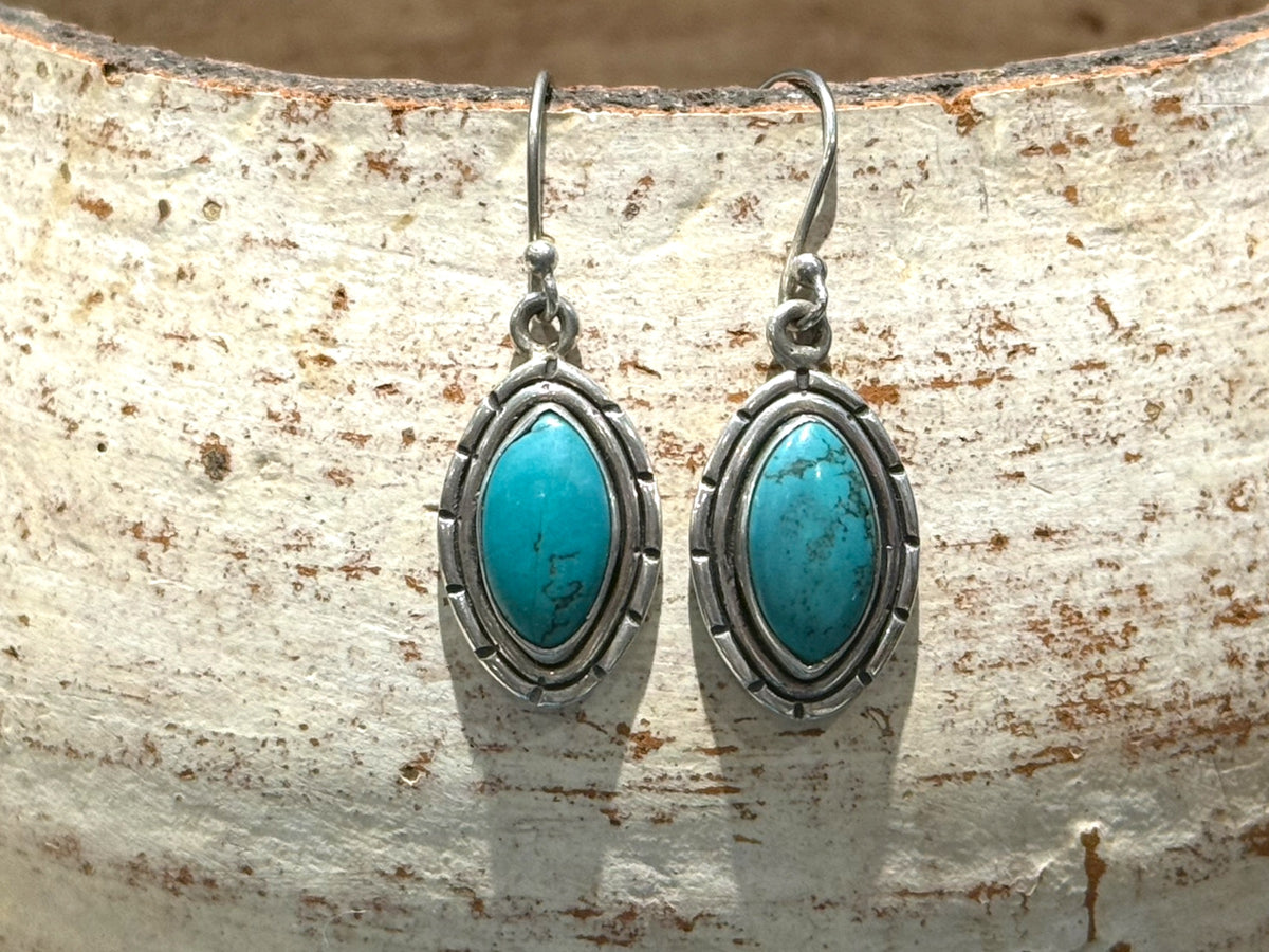 Our southwest earrings are made from Arizona turquoise set in wide sterling silver mounts. Length 4 cm including hook