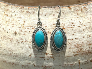 Our southwest earrings are made from Arizona turquoise set in wide sterling silver mounts. Length 4 cm including hook