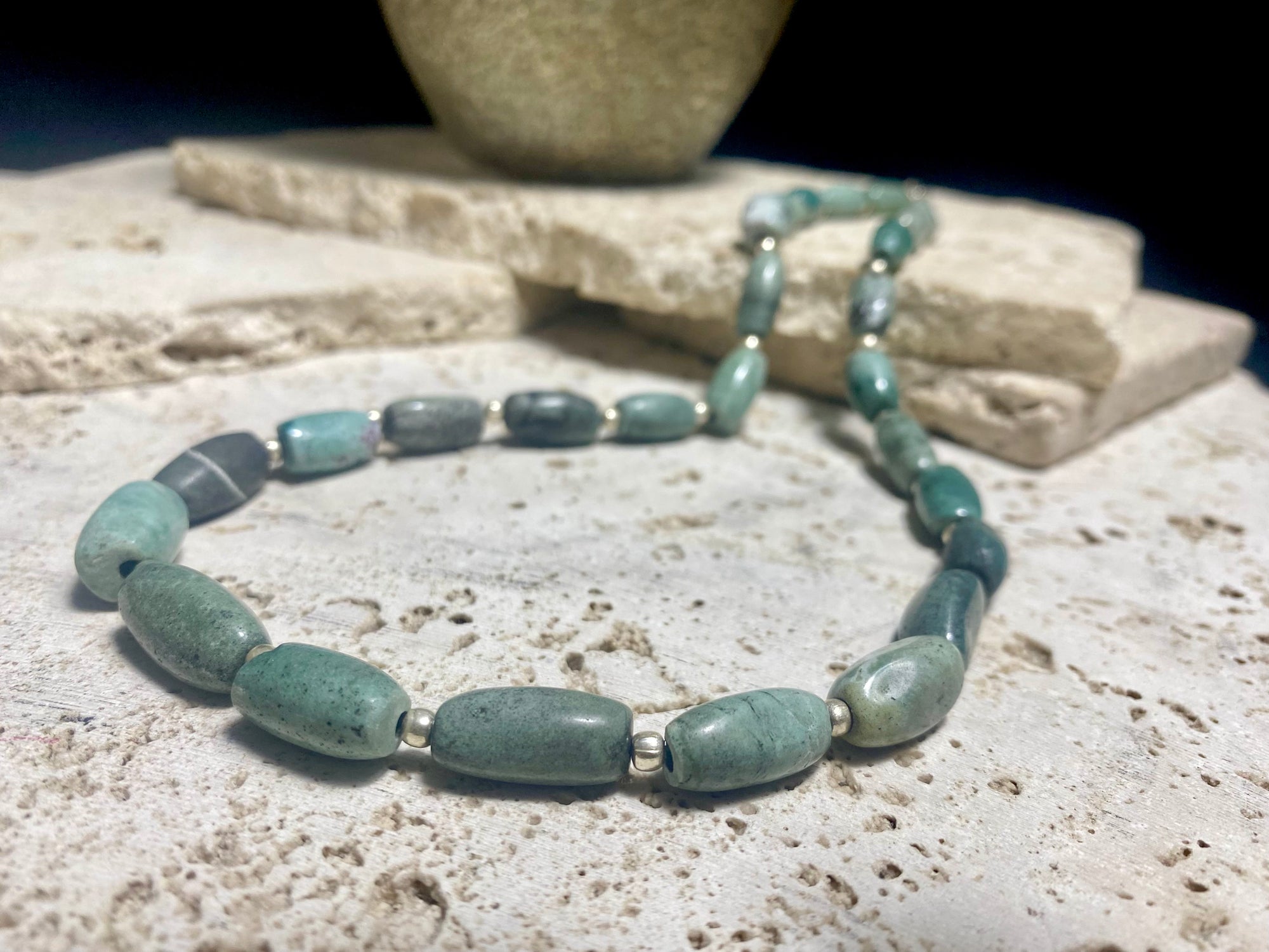 Unique necklace made up of very old natural blue green stone beads. Sterling silver spacer beads and hook clasp. This is a unisex necklace. Length 48 cm