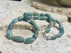 Unique necklace made up of very old natural blue green stone beads. Sterling silver spacer beads and hook clasp. This is a unisex necklace. Length 48 cm