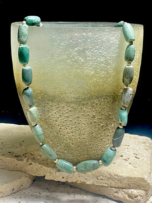 Unique necklace made up of very old natural blue green stone beads. Sterling silver spacer beads and hook clasp. This is a unisex necklace. Length 48 cm