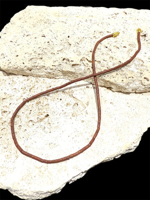 Natural serpentine bead necklace in a mat red-brown colour. Brass metal screw clasp. Measurements: 39 cm length, tube beads 2 mm diameter