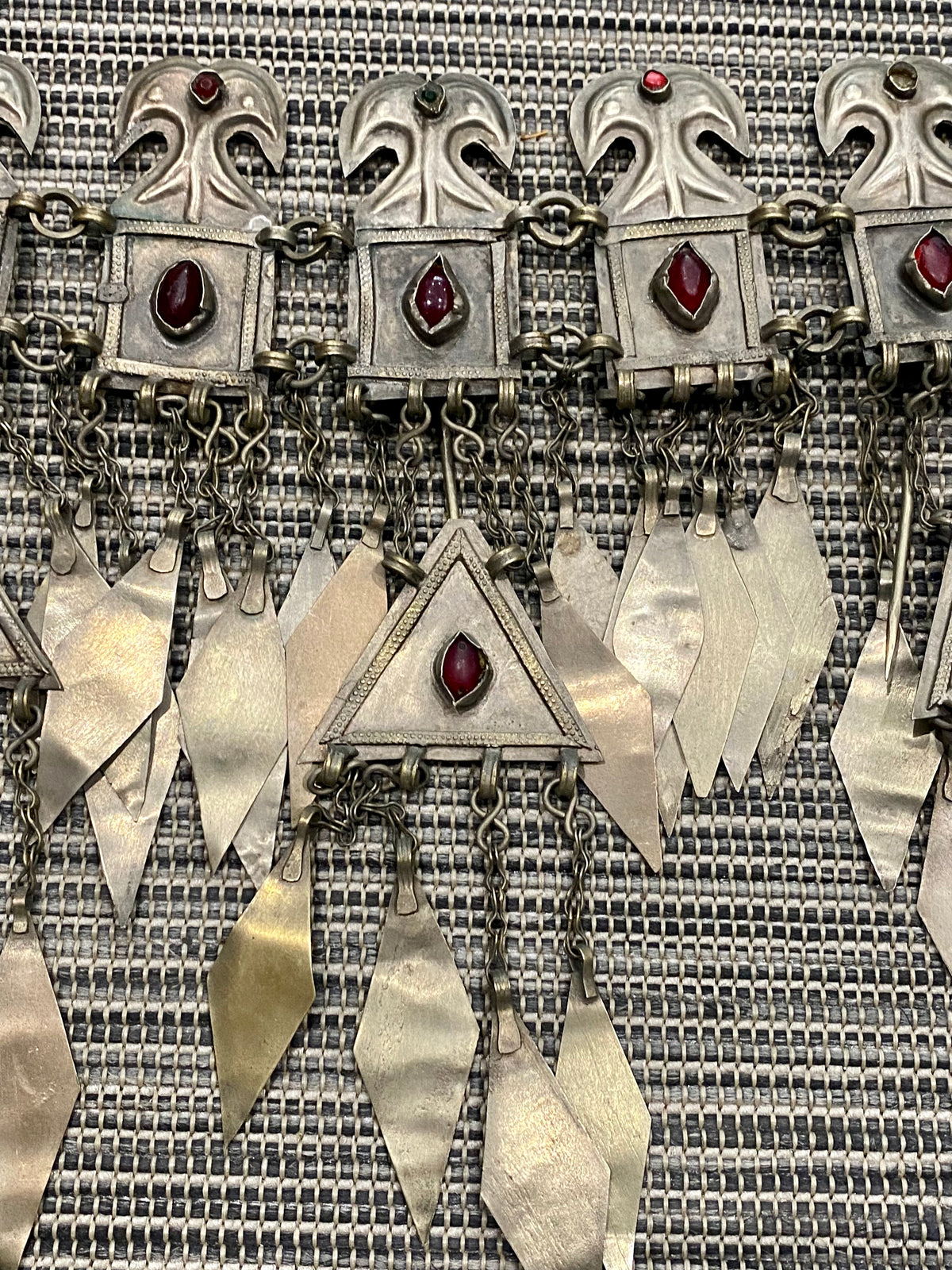 Ersari headdress consisting of a metal gaashbaagh & a high embroidered conical hat into which it attached with long spikes. The cap is quilted cotton covered in velvet and detailed silk embroidery. An heirloom piece, dating from 1870-1890. Cap height 23 cm. Tiara: width 53 cm, height of band 7 cm, side dangles 44 cm