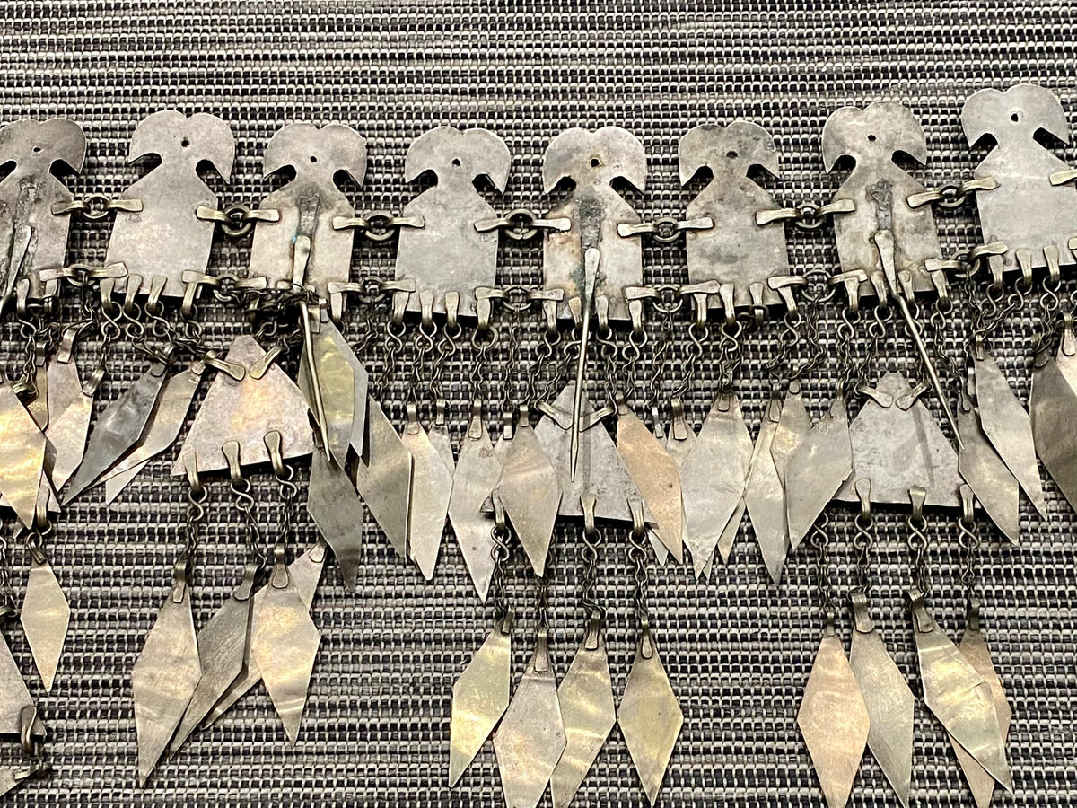 Ersari headdress consisting of a metal gaashbaagh & a high embroidered conical hat into which it attached with long spikes. The cap is quilted cotton covered in velvet and detailed silk embroidery. An heirloom piece, dating from 1870-1890. Cap height 23 cm. Tiara: width 53 cm, height of band 7 cm, side dangles 44 cm