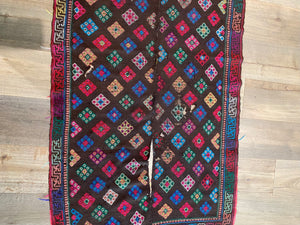 Yathra weaving, from the Chumey Valley in Bumthang, Bhutan. Hand spun and natural dyed yarn is backstrap woven into wool panels, then embroidered with wool thread. Mid 20th century. This textile is called a denkeb and was likely used as a rain cloak. Its condition is commensurate with its age. Measurements: 173 x 84 cm
