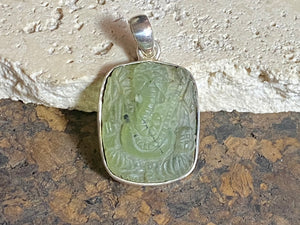 Unique, hand carved prehnite pendant depicting Ganesh. Sterling silver frame and bail. Measurements: height 3.6 cm including bail, width 2.1 cm. This is a unisex pendant and can be worn by men or women