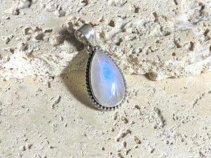 Teardrop rainbow moonstone pendant set in lovely twisted silver sterling silver surround with a generous bail to take a large chain or cord. A lovely stone with blue fire.&nbsp;  Measurements: Length including bail 3.6 cm, width at widest point 1.8 cm