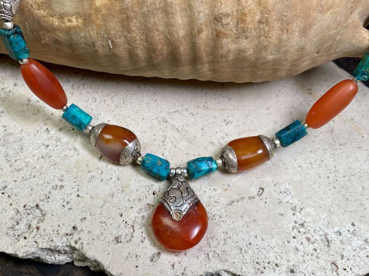 Antique Tibetan fluted carnelian beads are matched with silver capped carnelian beads and chrysocolla to give this necklace a lovely antique feel. Length 47 cm, pendant height 3.5 x width 2.2 cm