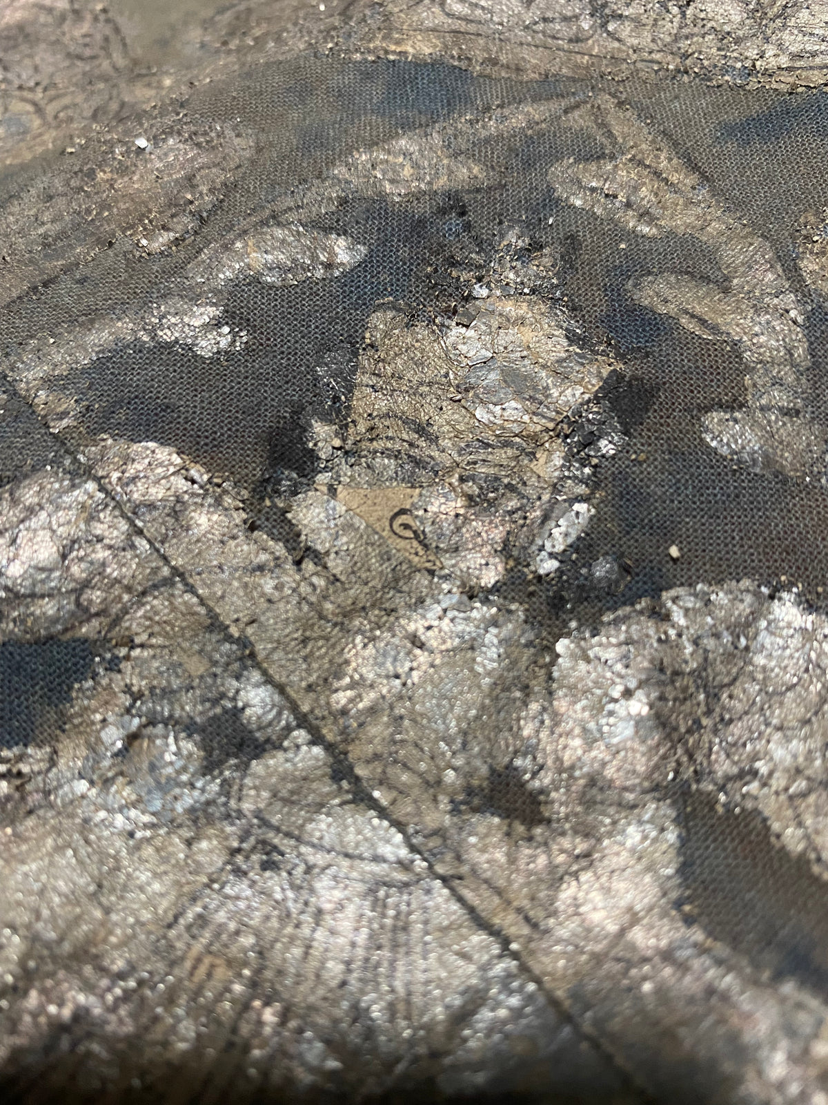 Pichwai temple hanging, silver leaf on a ground of handwoven cotton, featuring Krishna, gopis and apsaras. This devotional cloth hanging was made by Shri Nathji devotees of the Pushti Marg Sect. A large and rare circular-patterned example dating to late 19th Century and a collector's item. Measurements: 173 x 157 cm.