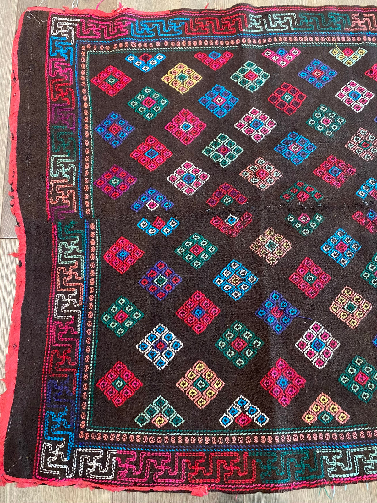 Yathra weaving, from the Chumey Valley in Bumthang, Bhutan. Hand spun and natural dyed yarn is backstrap woven into wool panels, then embroidered with wool thread. Mid 20th century. This textile is called a denkeb and was likely used as a rain cloak. Its condition is commensurate with its age. Measurements: 173 x 84 cm