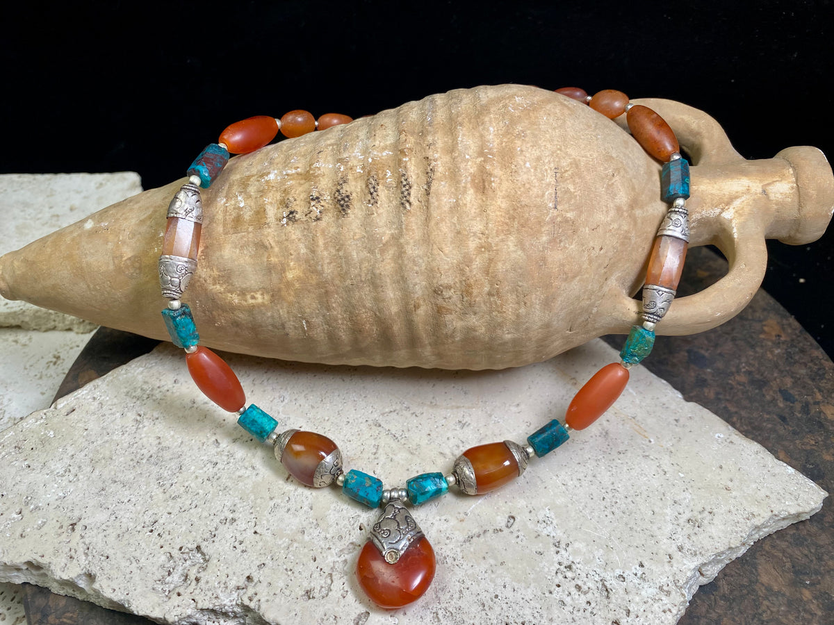 Antique Tibetan fluted carnelian beads are matched with silver capped carnelian beads and chrysocolla to give this necklace a lovely antique feel. Length 47 cm, pendant height 3.5 x width 2.2 cm