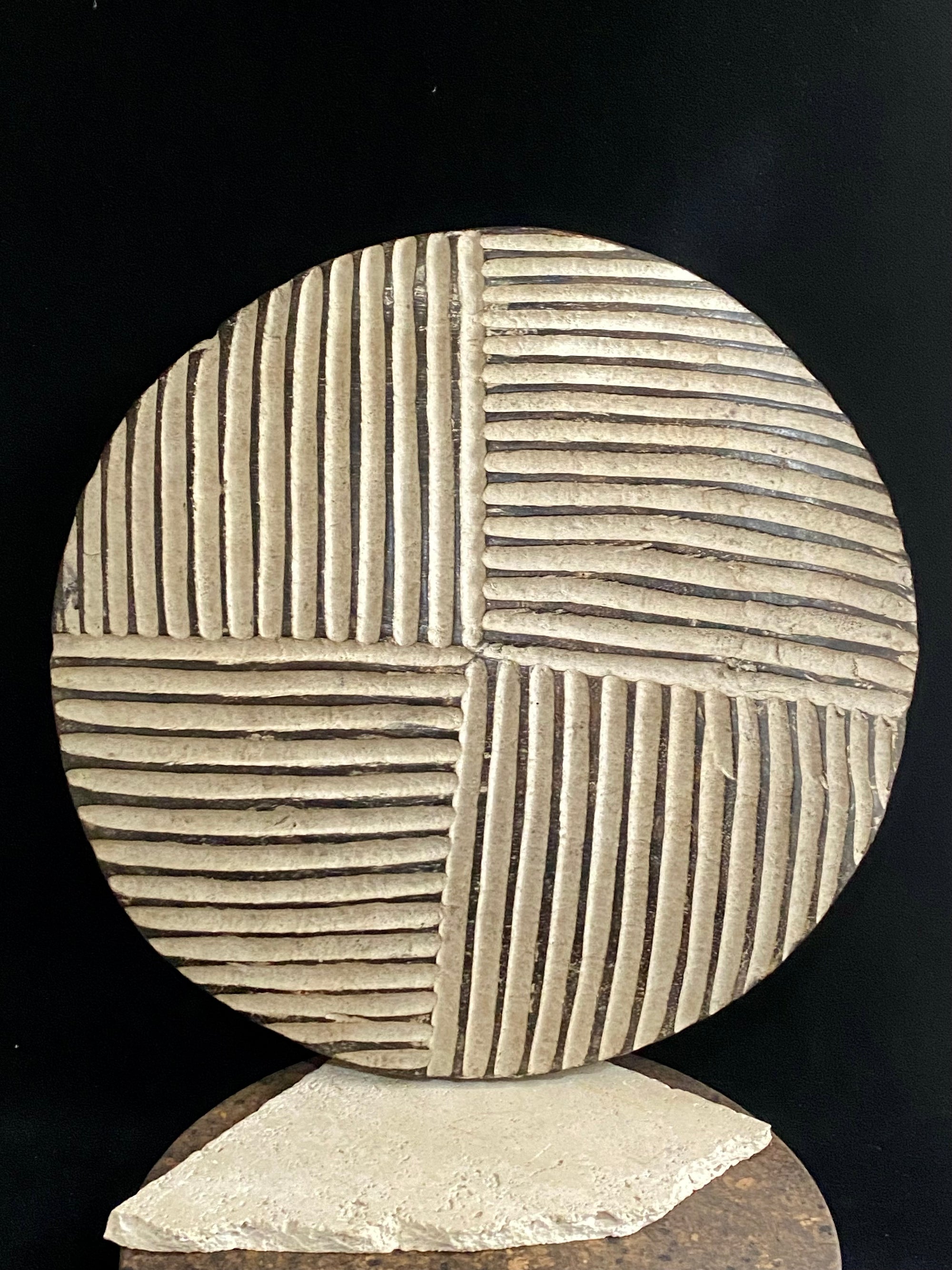 Round shield, Kuba people, vintage 1930's.  This shield features a patination of intersecting geometric lines and white pigment patina.  Measurements: diameter 42 cm, height approximately 6 cm