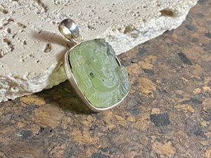 Unique, hand carved prehnite pendant depicting Ganesh. Sterling silver frame and bail. Measurements: height 3.6 cm including bail, width 2.1 cm. This is a unisex pendant and can be worn by men or women