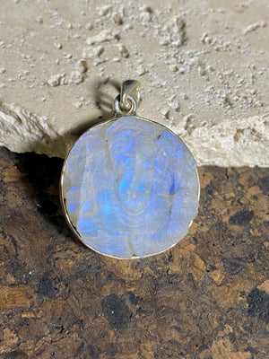 Hand carved rainbow moonstone pendants depicting Ganesh. These are unique pieces, with a beautiful luminosity enhanced by the depth of the stones. Sterling silver frame and bail. The bail is generous enough to allow a large chain or cord to pass through.