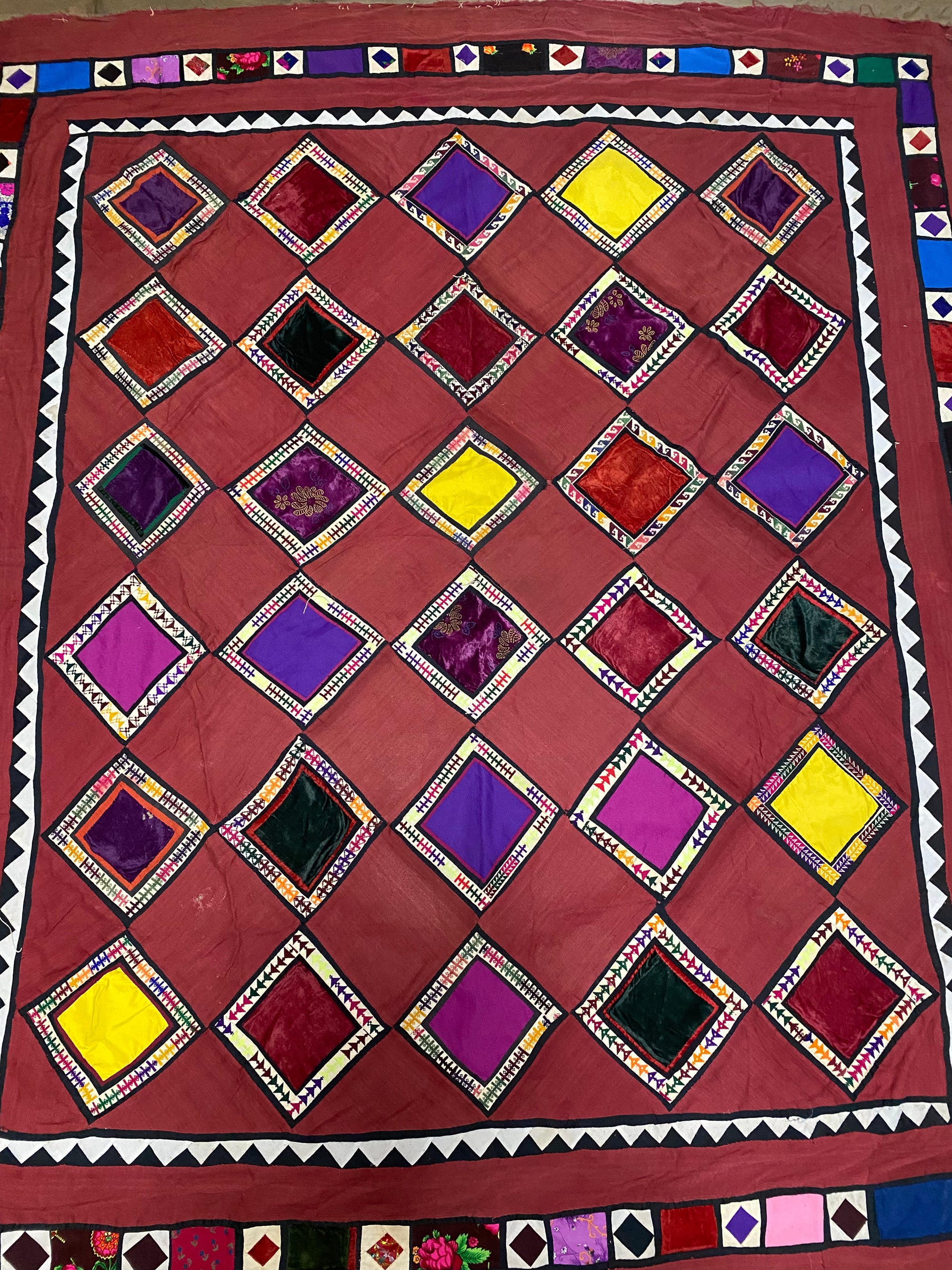 Uzbeki Afghani korak patchwork. Geometric patchwork of cotton, silk, velvet & embroidered fabric squares, framed with embroidery. Traditionally used by nomads as coverlets or wall hangings in their tents. Protects against evil eye. This is a fine example of this style of workmanship. Early 20th C: 200 x 173 cm