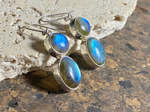 Large, oval labradorite earrings, crafted from cabochon labradorite stones set in sterling silver and finished with large hooks. Measurements: height 4.8 cm x width 1.2 cm