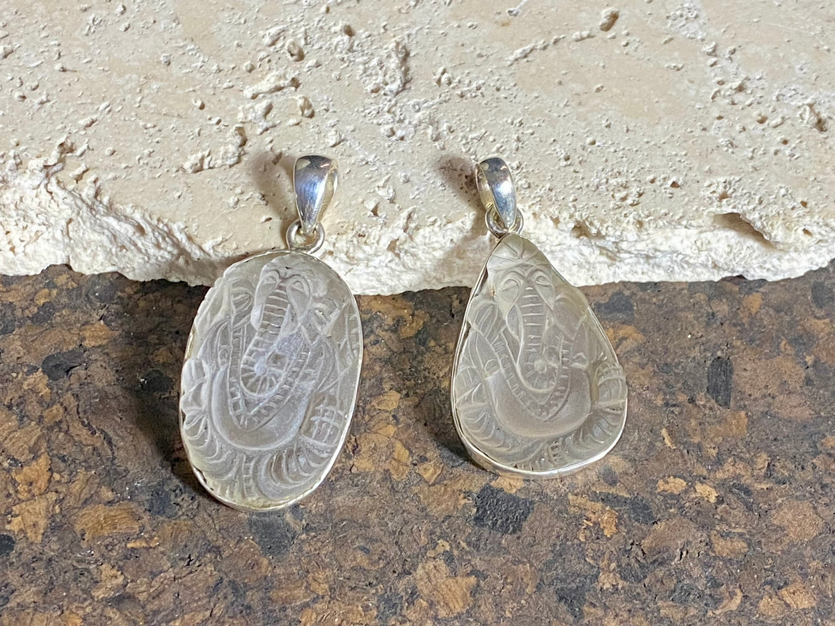 Hand carved clear quartz pendants depicting Ganesh. These are unique pieces with a beautiful clarity. Sterling silver frames and bails.  These unisex quartz pendants will suit both men and women.