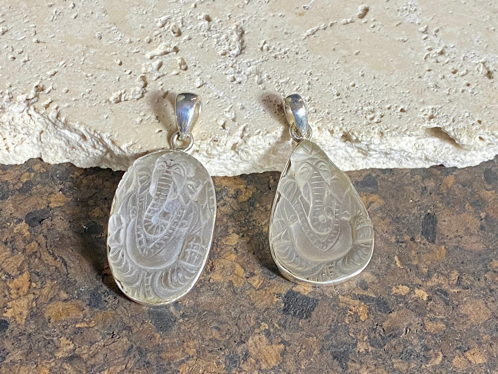 Hand carved clear quartz pendants depicting Ganesh. These are unique pieces with a beautiful clarity. Sterling silver frames and bails.  These unisex quartz pendants will suit both men and women.