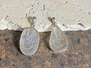 Hand carved clear quartz pendants depicting Ganesh. These are unique pieces with a beautiful clarity. Sterling silver frames and bails.  These unisex quartz pendants will suit both men and women.