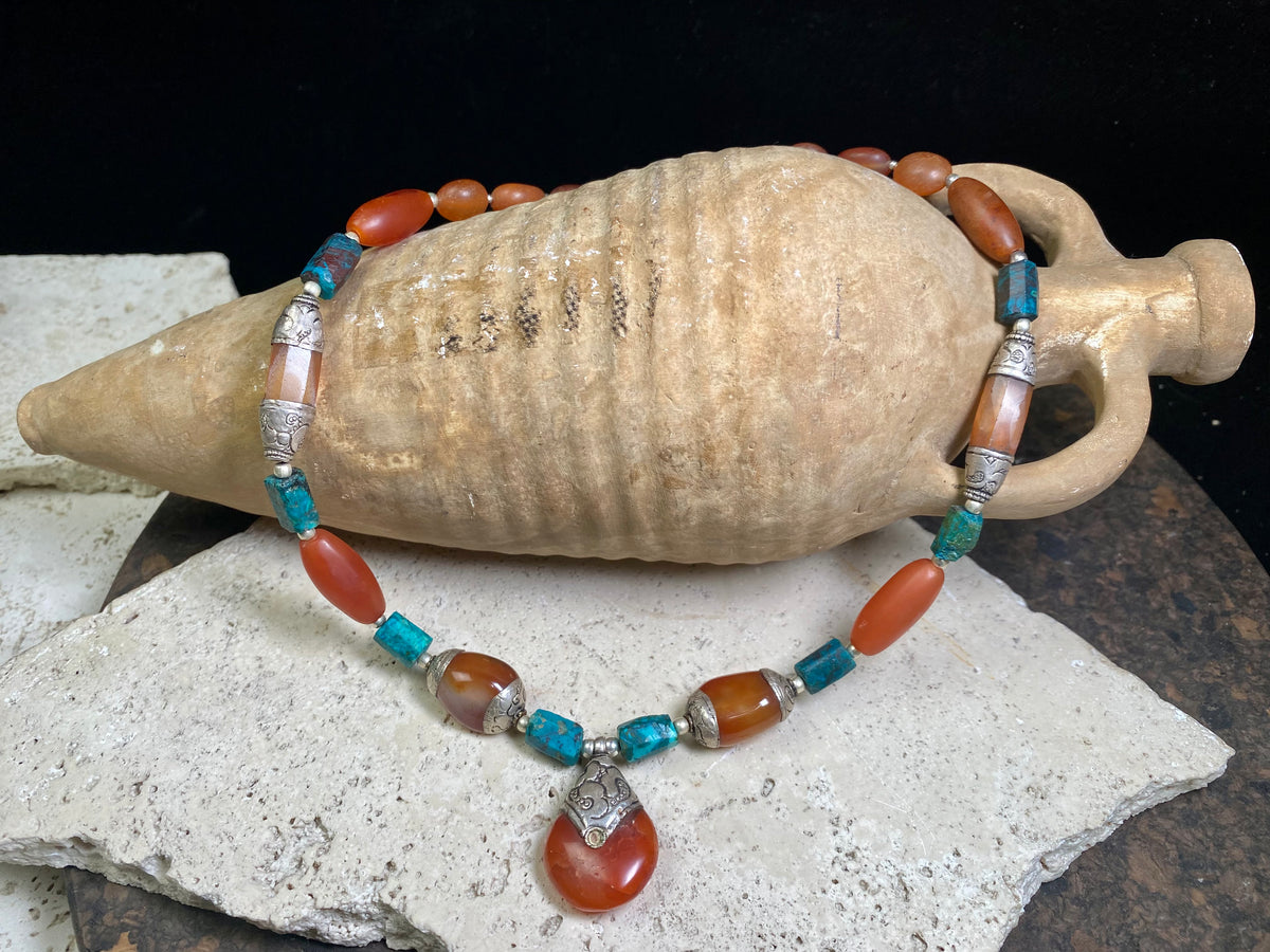 Antique Tibetan fluted carnelian beads are matched with silver capped carnelian beads and chrysocolla to give this necklace a lovely antique feel. Length 47 cm, pendant height 3.5 x width 2.2 cm