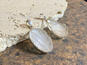 Hand carved clear quartz pendants depicting Ganesh. These are unique pieces with a beautiful clarity. Sterling silver frames and bails.  These unisex quartz pendants will suit both men and women.