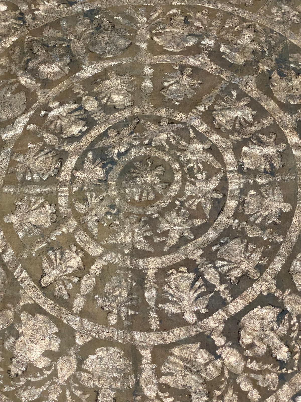 Pichwai temple hanging, silver leaf on a ground of handwoven cotton, featuring Krishna, gopis and apsaras. This devotional cloth hanging was made by Shri Nathji devotees of the Pushti Marg Sect. A large and rare circular-patterned example dating to late 19th Century and a collector's item. Measurements: 173 x 157 cm