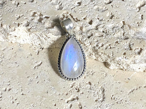 Teardrop rainbow moonstone pendant set in lovely twisted silver sterling silver surround with a generous bail to take a large chain or cord. A lovely stone with blue fire.&nbsp;  Measurements: Length including bail 3.6 cm, width at widest point 1.8 cm